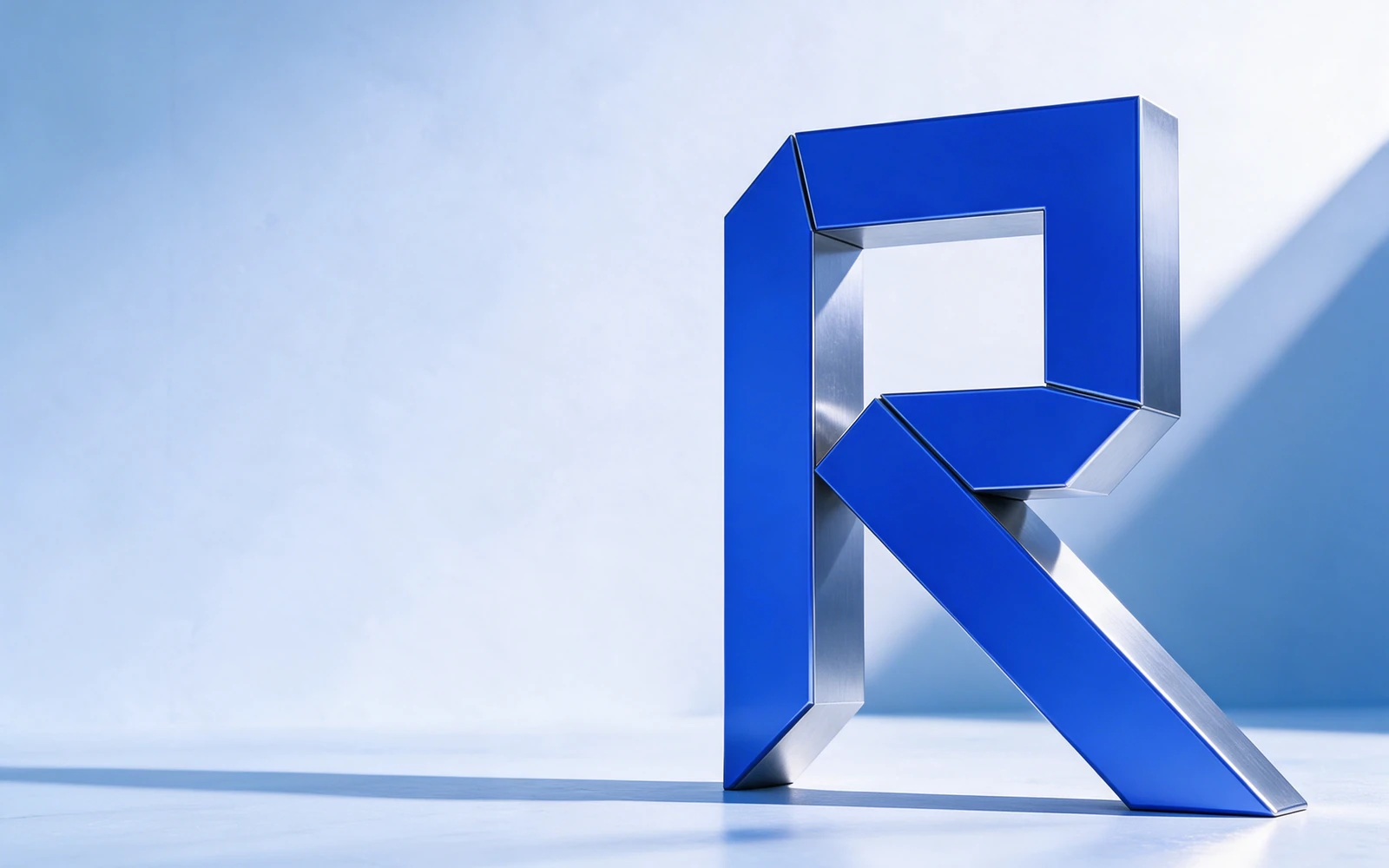 A monumental folded RELAY R in cobalt and brushed metal, presented as a sculptural technology identity