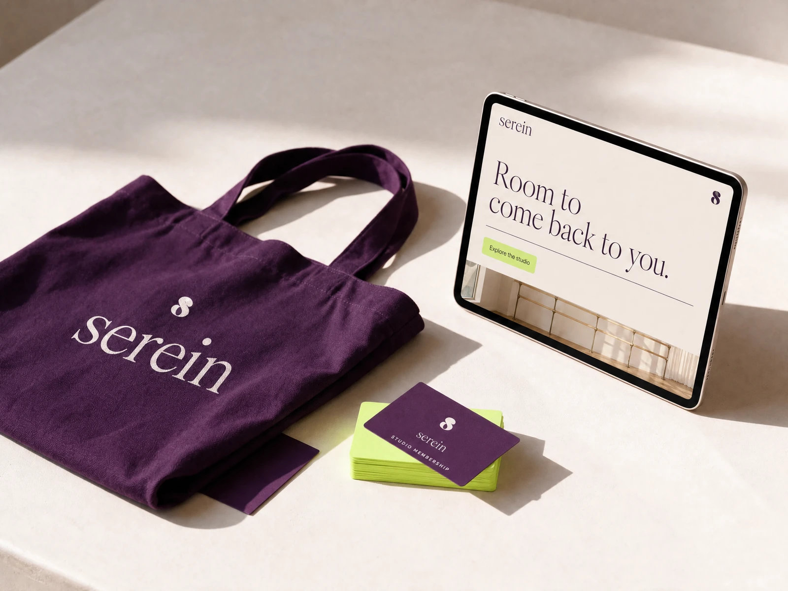 SEREIN concept studio identity applied to aubergine and lime wellness stationery and tactile materials